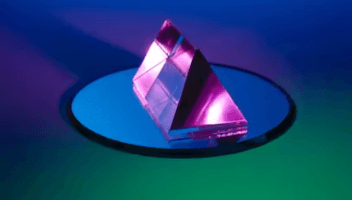 Purple glass pyramid on top of a mirror