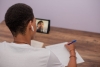 blog post header image of a young man participating remotely in an online class