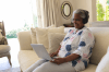 woman sitting on couch using a laptop