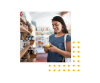 Image of woman looking at a coffee mug in a store