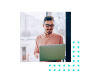 Man with glasses smiling at laptop