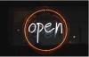 Orange and white neon sign saying 'OPEN'
