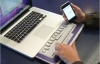 Hands at a laptop using a keyboard for the vision-impaired