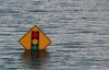 A traffic light half-submerged in water