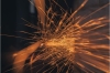 Orange sparks flying against a dark background