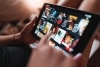 A closeup of someone on their smart device scrolling for a movie or T.V. show to watch on a streaming platform.