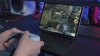 A person plays a mobile video game with a tablet and controller