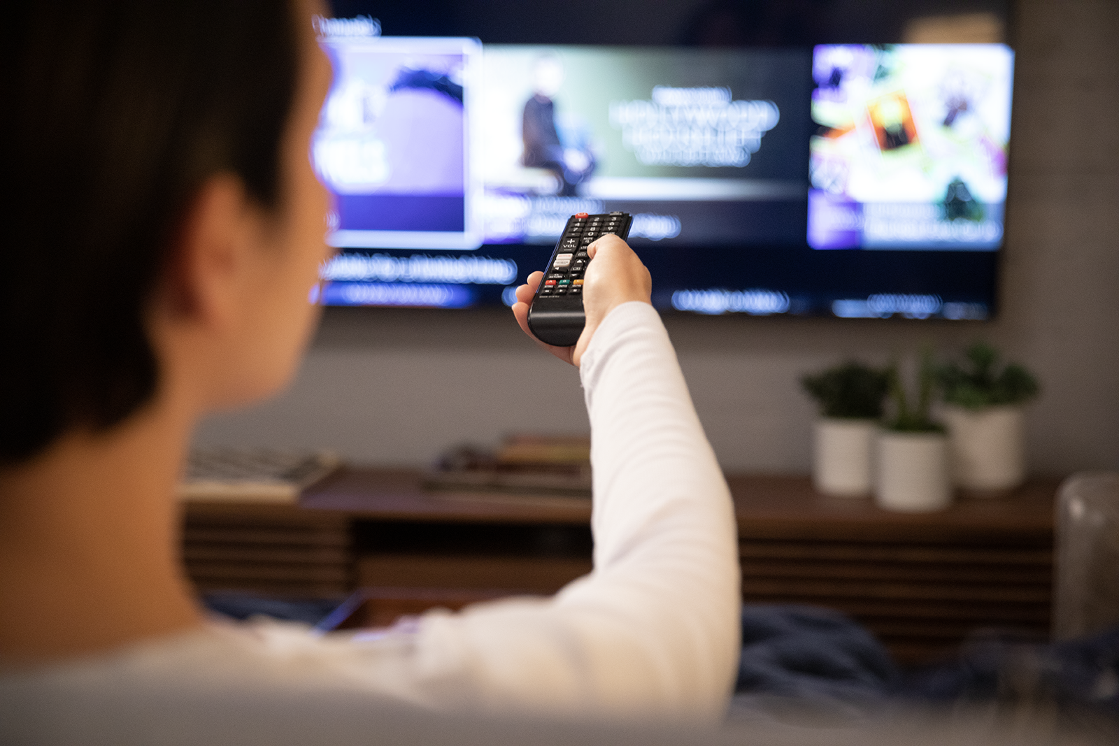 Man watching streaming tv using a remote