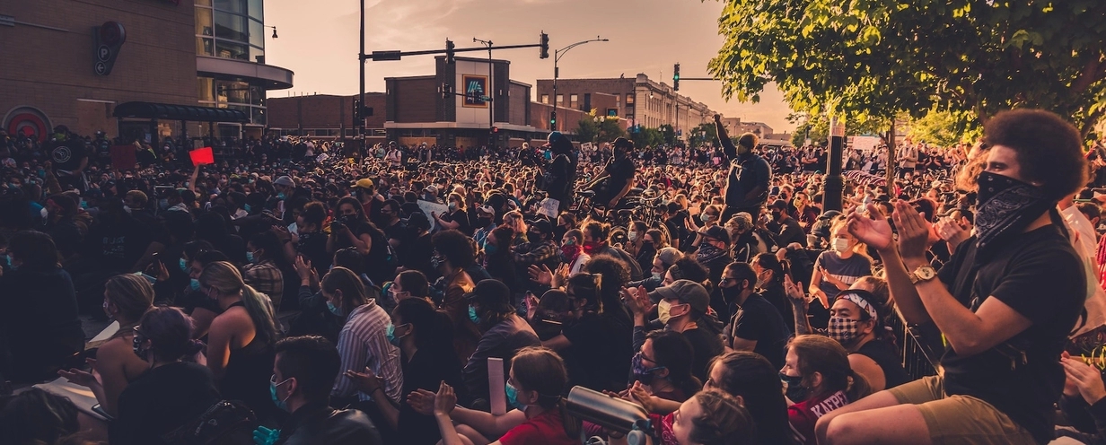 Photo of a crowd in COVID masks protesting