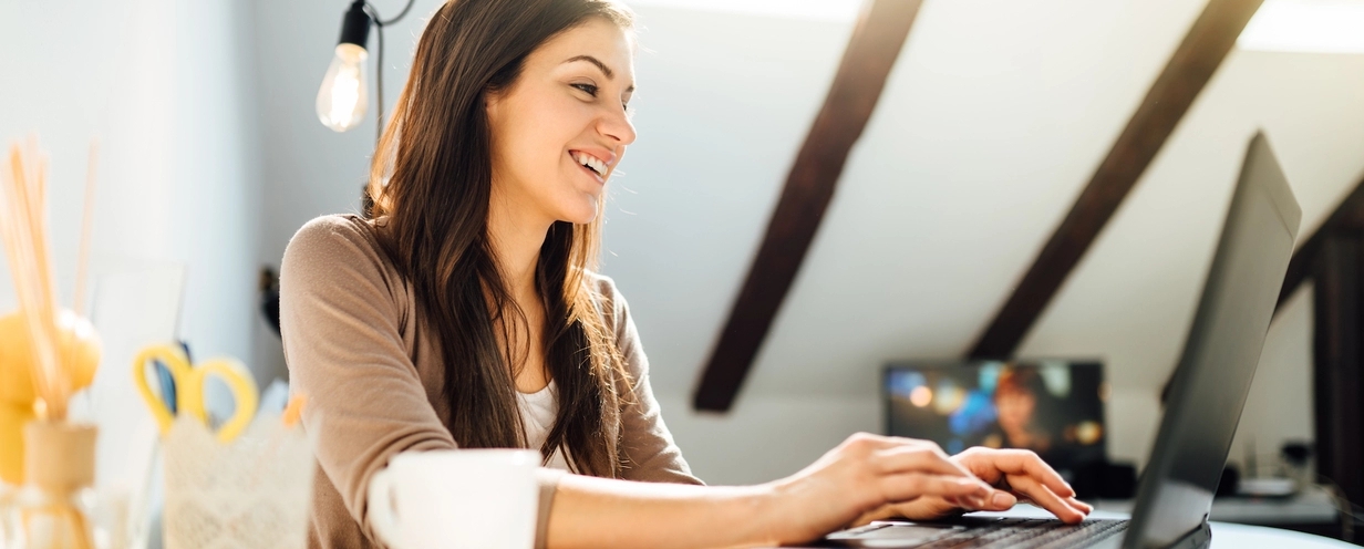 Image of a woman working from home on her laptop