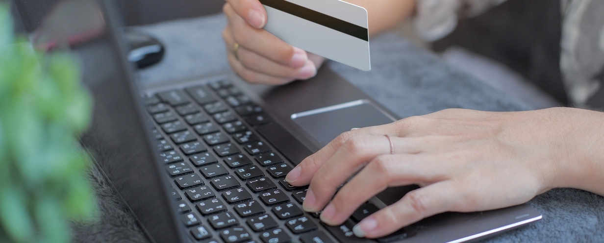 Photo of someone entering their credit card information into their laptop