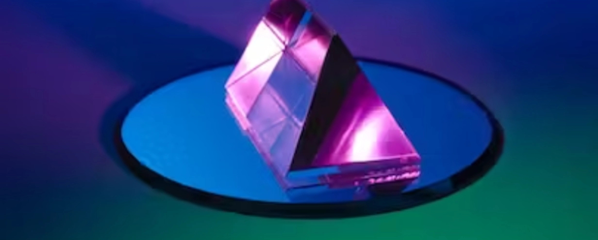 Image of a purple crystal sitting on top of a mirror