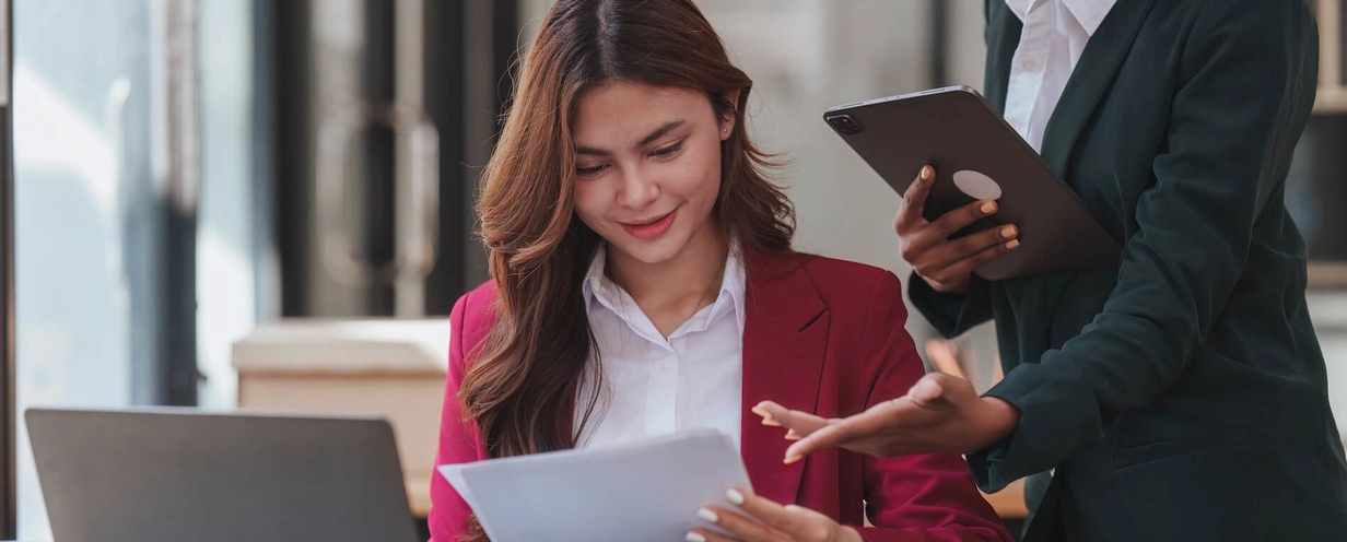 Two women in an office reviewing a document
