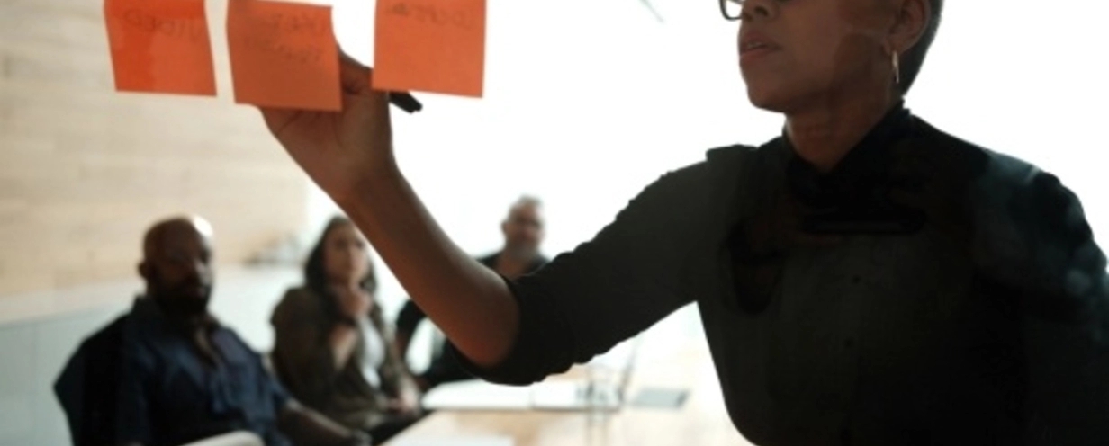 woman writing on post its