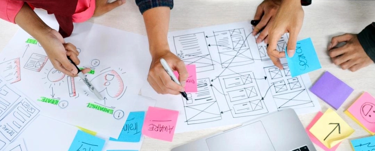 people drawing up plans 
