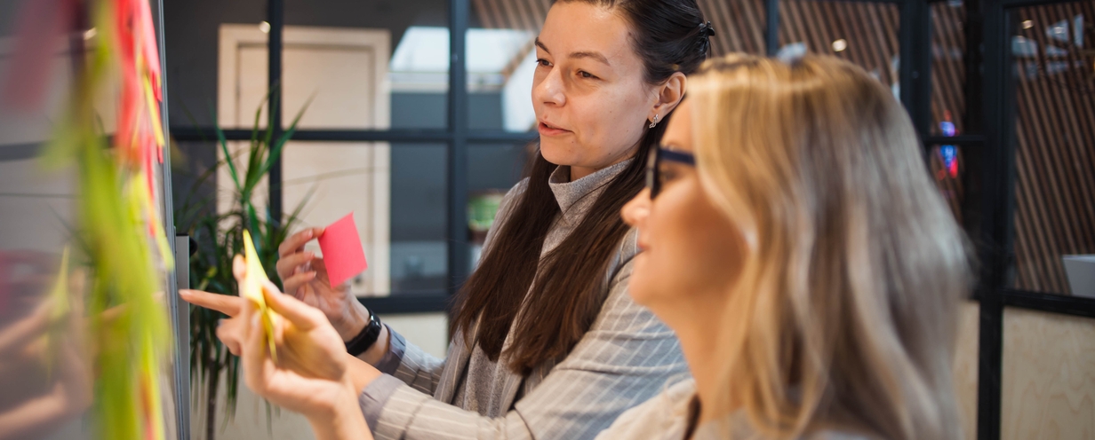 Photo of two women discussing agile product development
