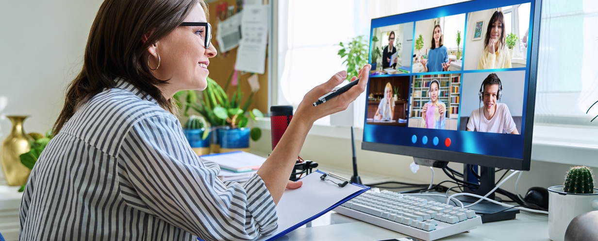 Woman conducting user research remotely with a panel of test participants on video
