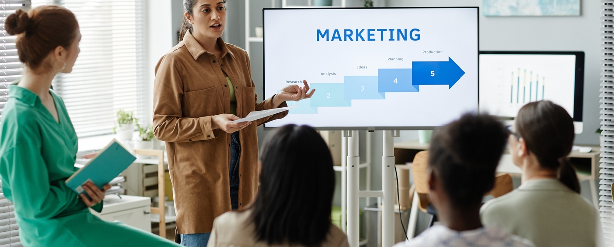 woman-presenting-marketing-strategy-to-colleagues