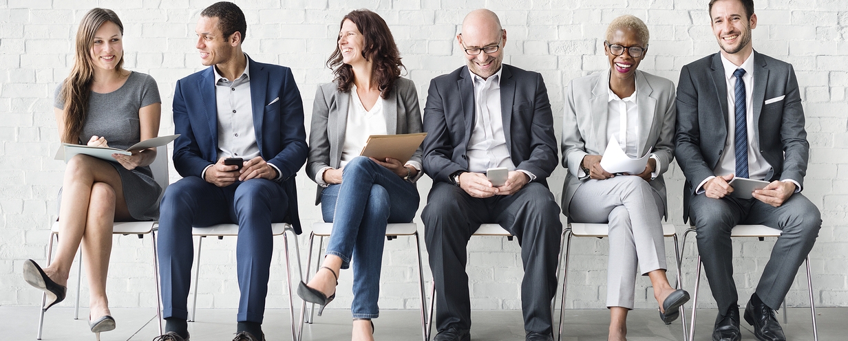 Picture of a group of people waiting to be interviewed