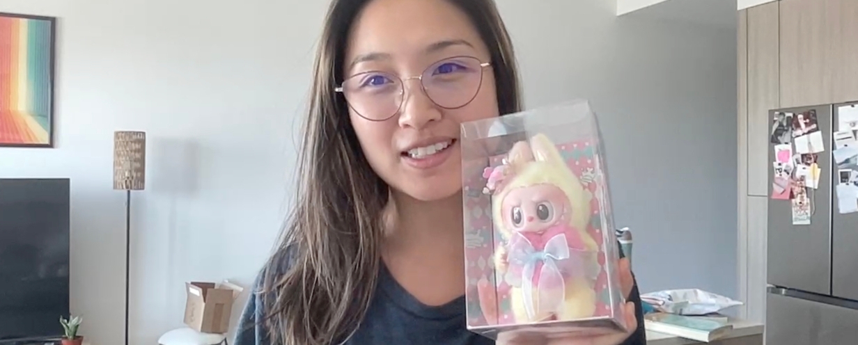 Screenshot of a woman holding a Labubu