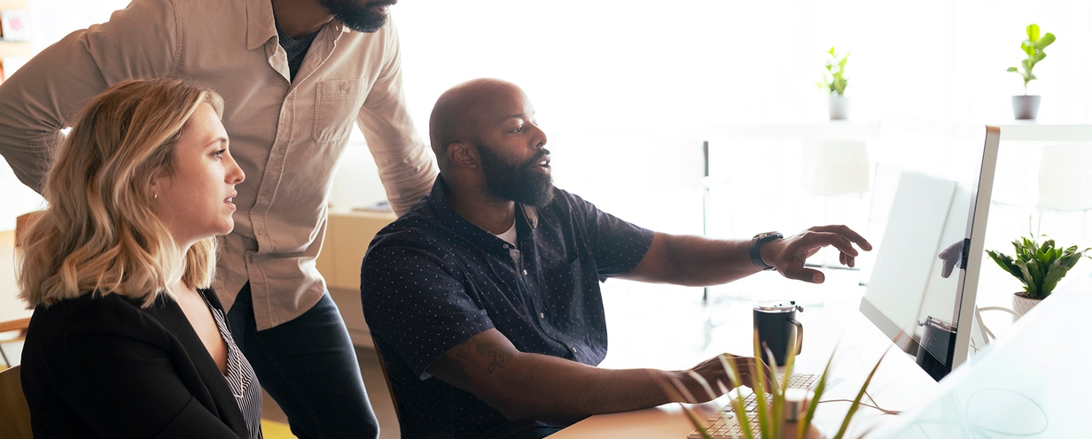 People collaborating while looking at a computer screen