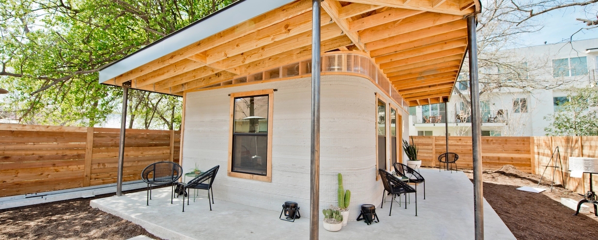 Small white home with a porch and yard