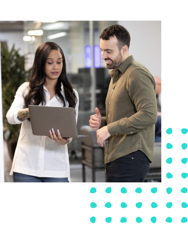 Image of man and woman looking at a laptop having a discussion