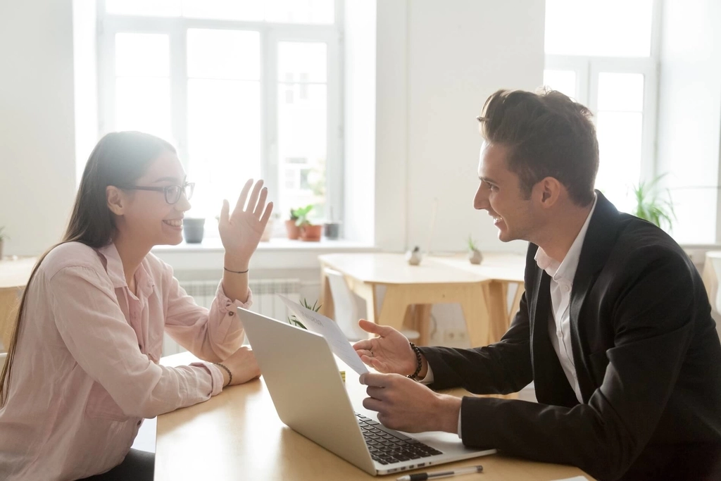 Two professionals conducting an in-person, moderated usability interview.