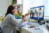 Woman conducting user research remotely with a panel of test participants on video