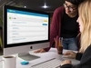Photo of two business professionals looking at a computer monitor