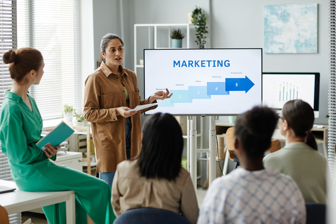 woman-presenting-marketing-strategy-to-colleagues