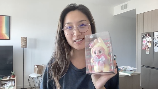 Screenshot of a woman holding a Labubu
