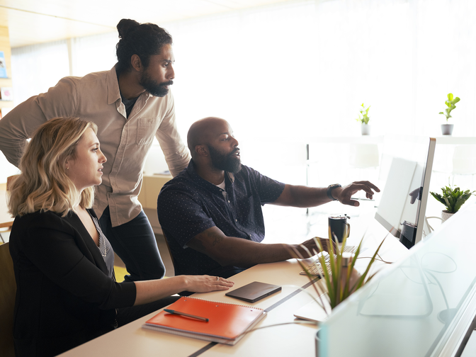 People collaborating while looking at a computer screen