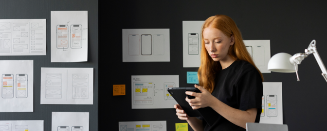 Hero Image for Awareness blog post #1 (2X: Increase Design Efficiency). An image of femal web designer in the office with notebook. Hero Image for Awareness blog post #1 (2X: Increase Design Efficiency). An image of femal web designer in the office with notebook.