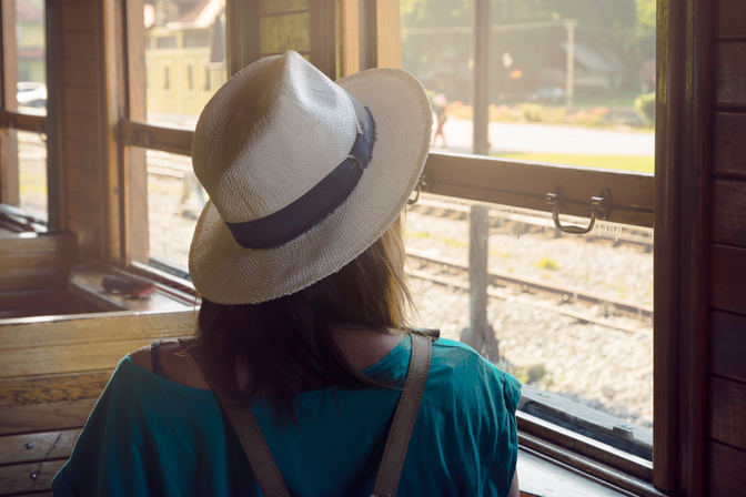 Woman facing away wearing a hat